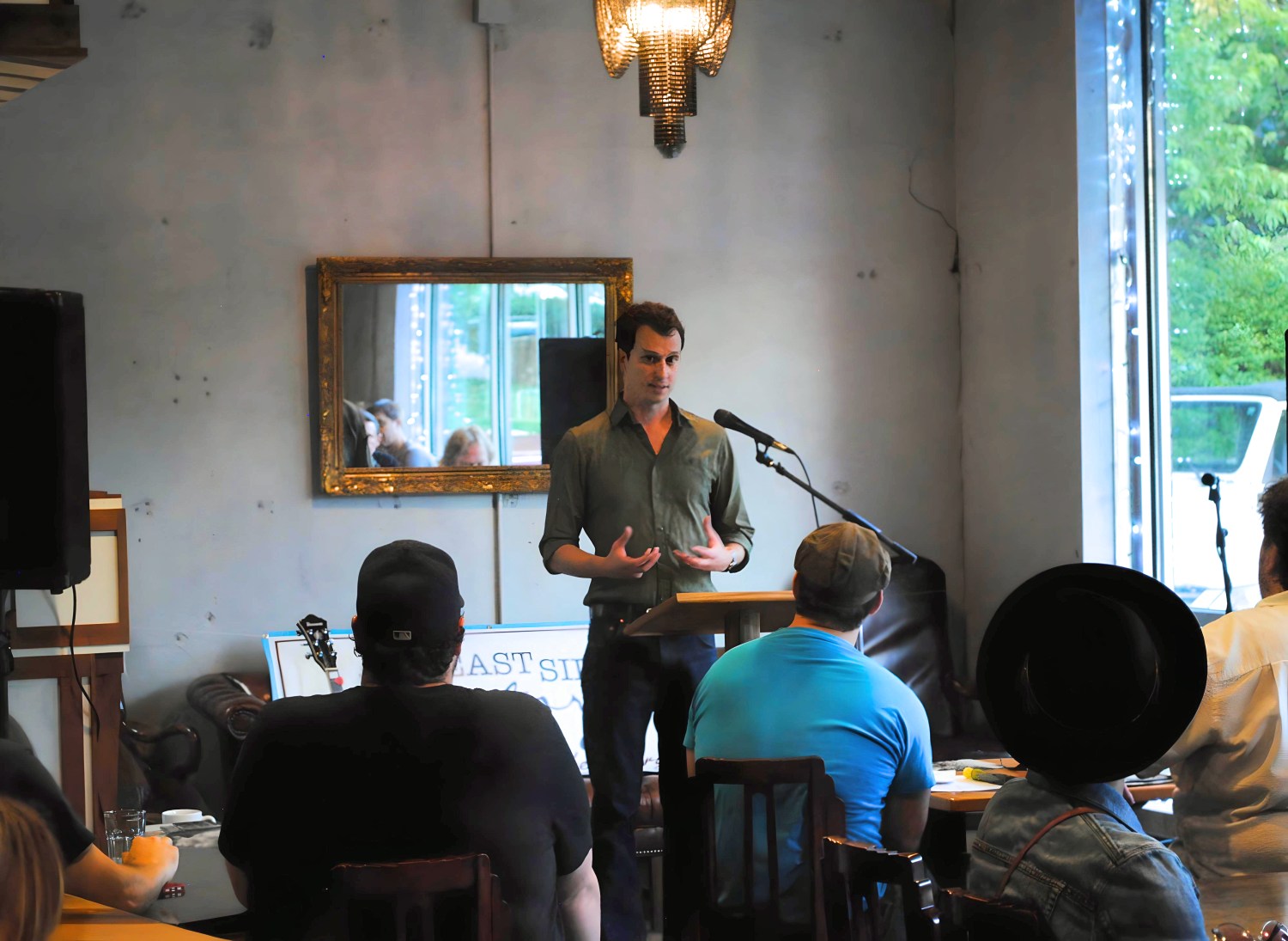 Matthew Leavitt Brown reading to an audience at a public event.
